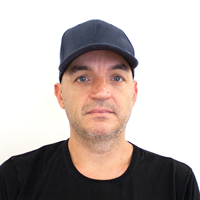 Photo of a man wearing a baseball cap.
