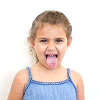 Photo of a child sticking her tongue out.