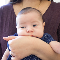 Photo of a baby being held by a woman.